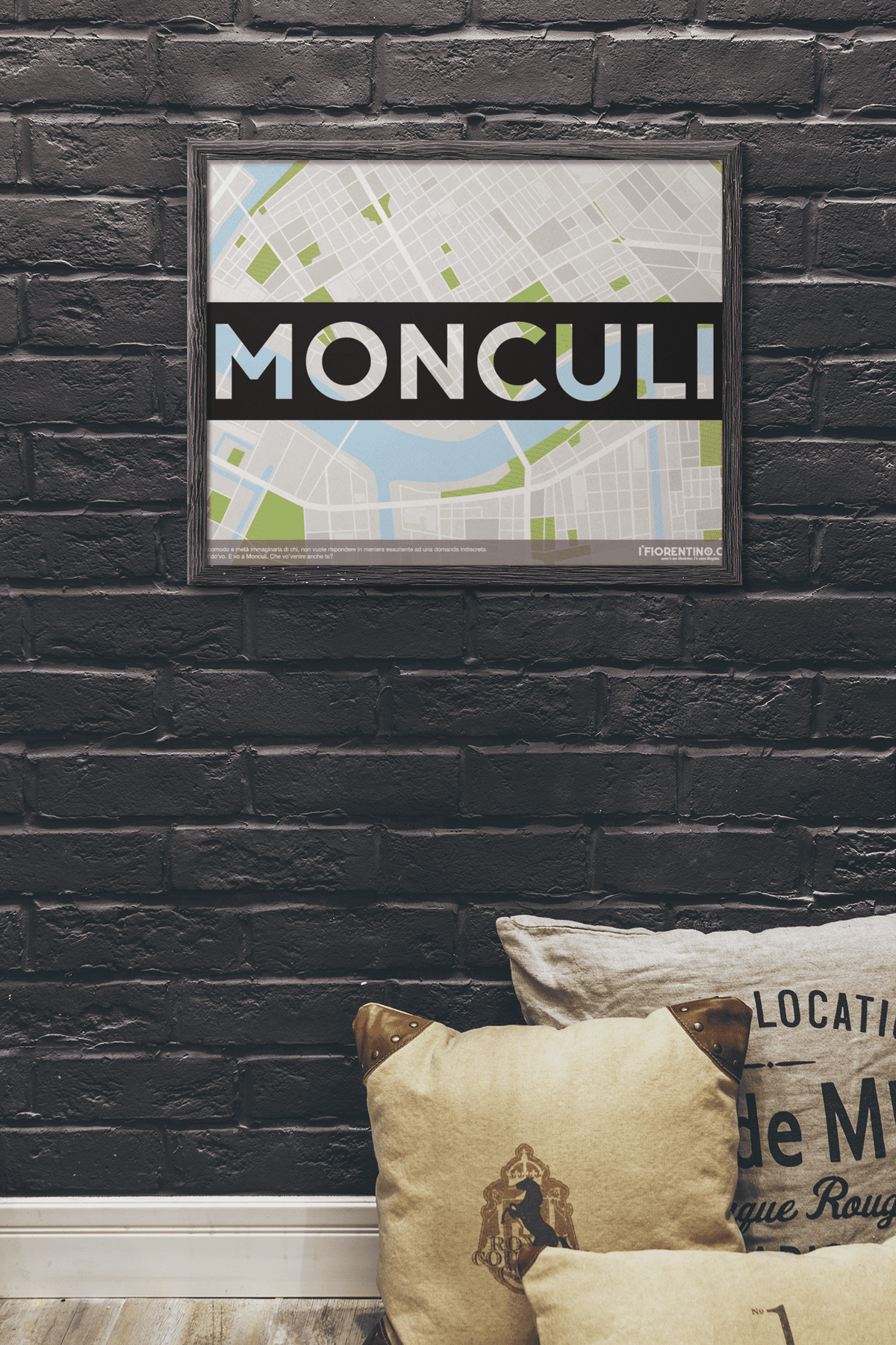 Il poster di Monculi appeso a una parete di mattoni scuri